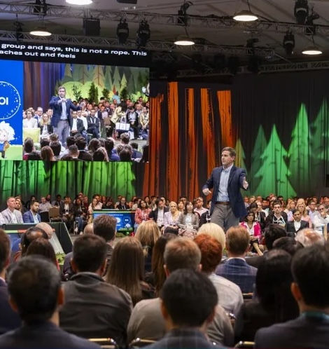 An event session from Dreamforce with full audience listening to speaker talk about AI