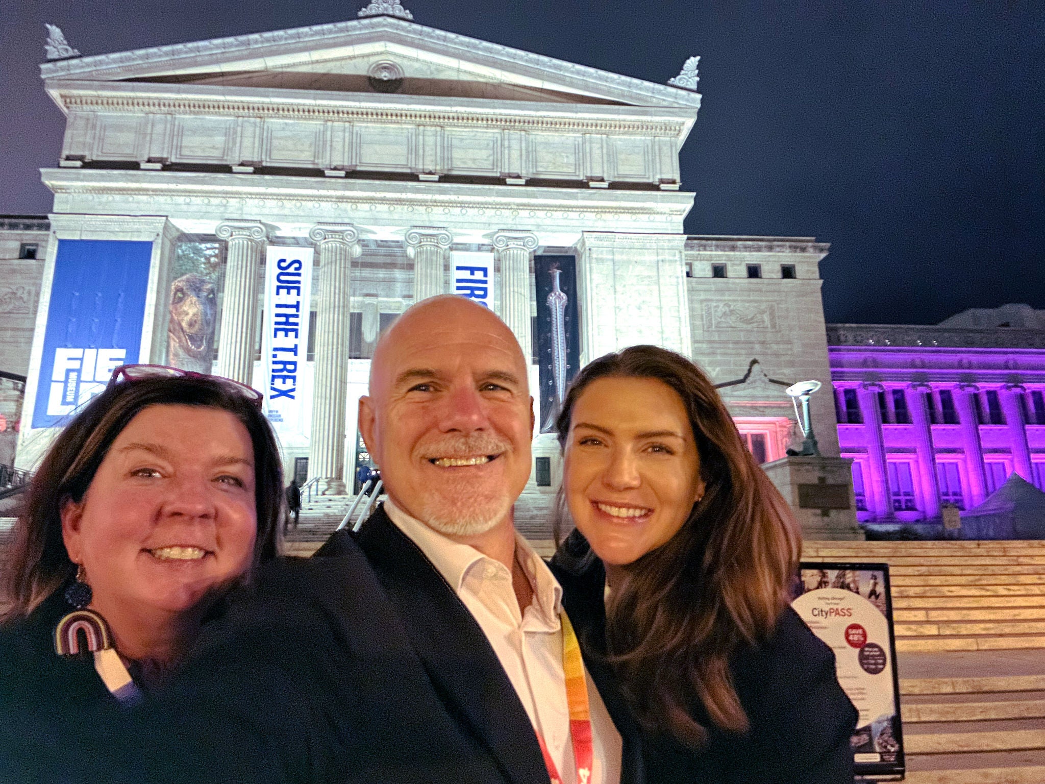 Michele, Michael, and Natalie pose outside at night.