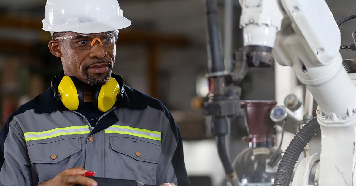 A man working on the lines and has headphones on. 