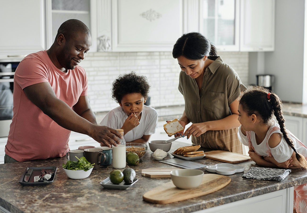 Family making a meal together in the kitchen.