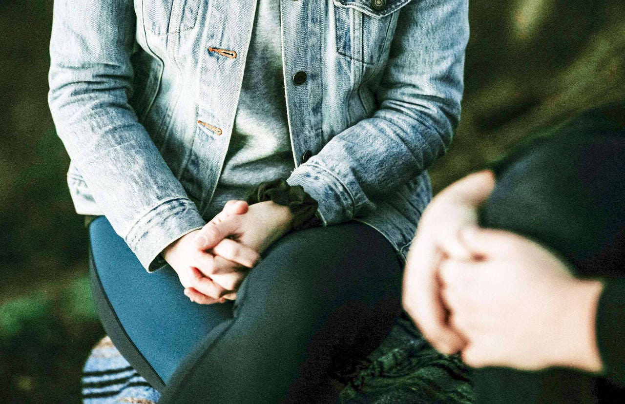 Two people talking and one with jean jacket.