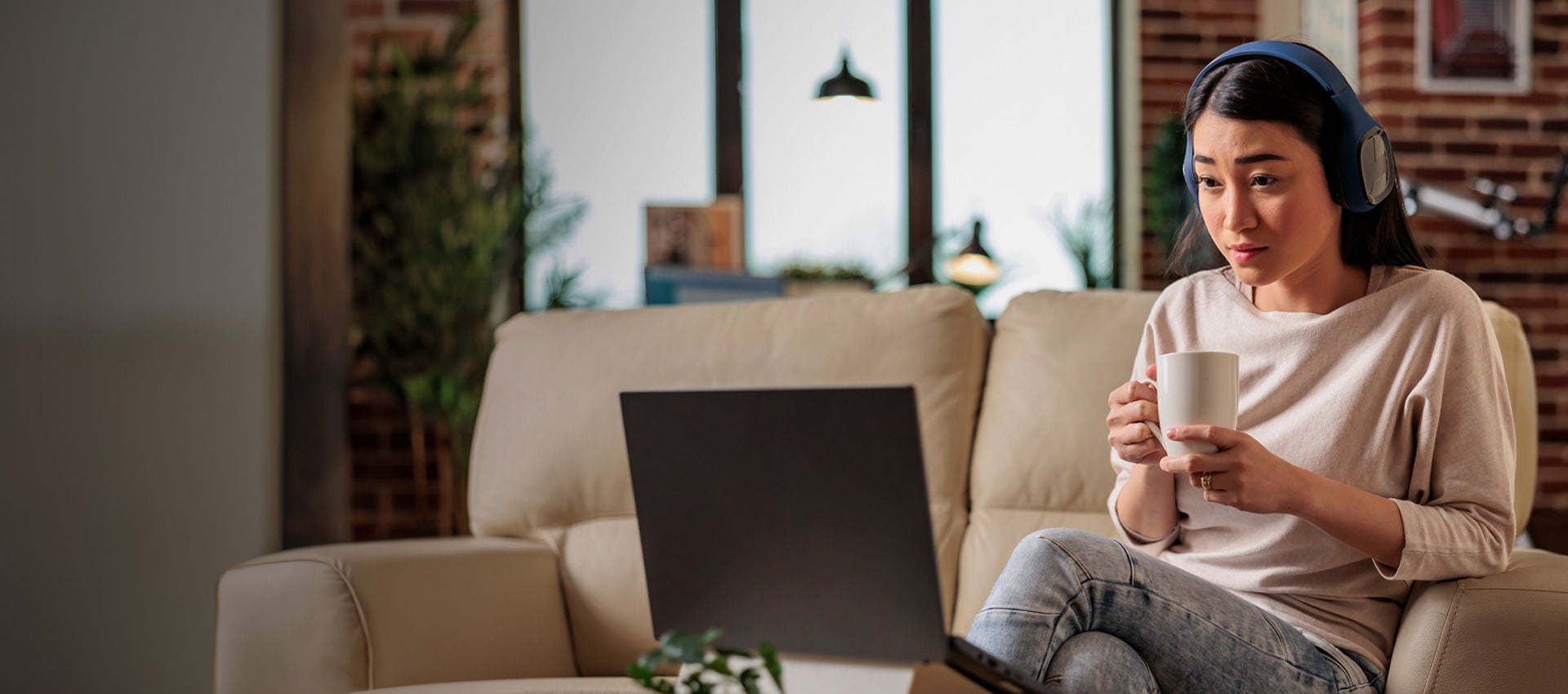 A woman watches a video while relaxing in her home.