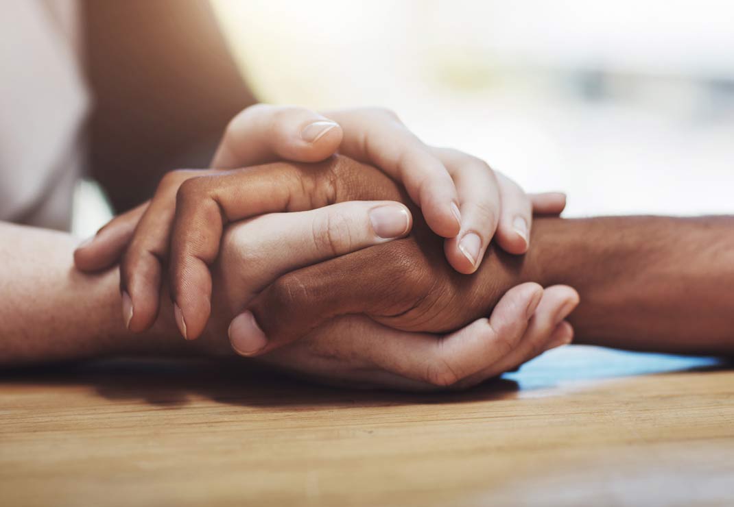 Patient holding hand with nurse with care.