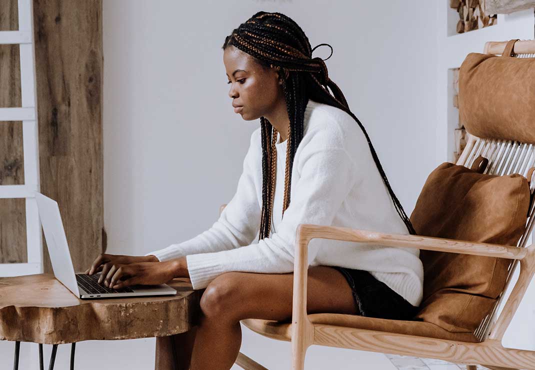 Woman on computer at home.