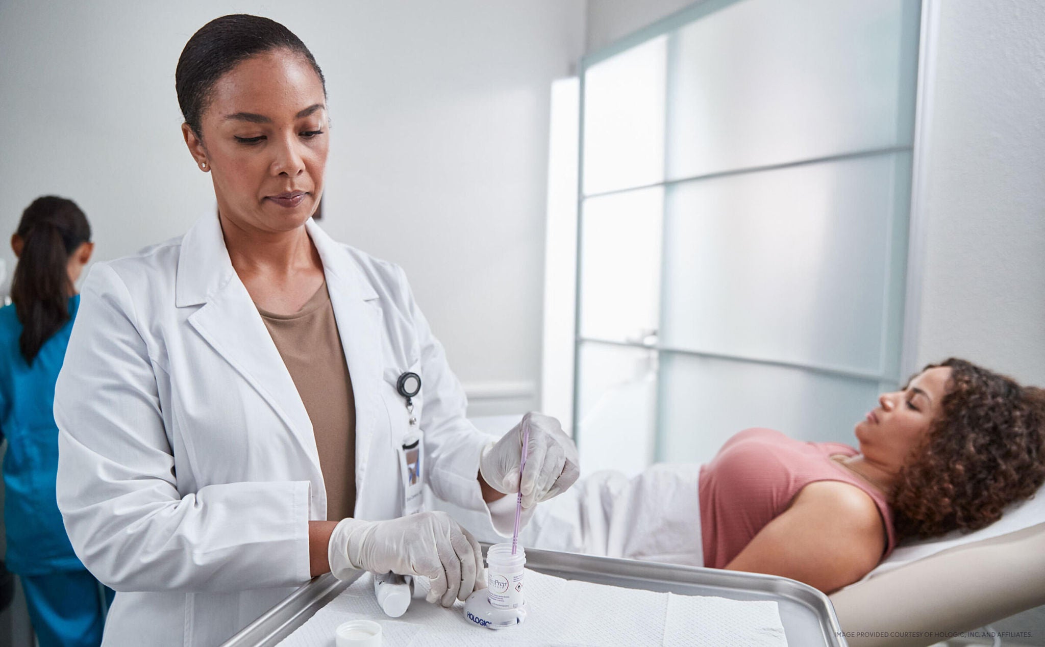 A doctor prepares a procedure on a patient in a medical office.