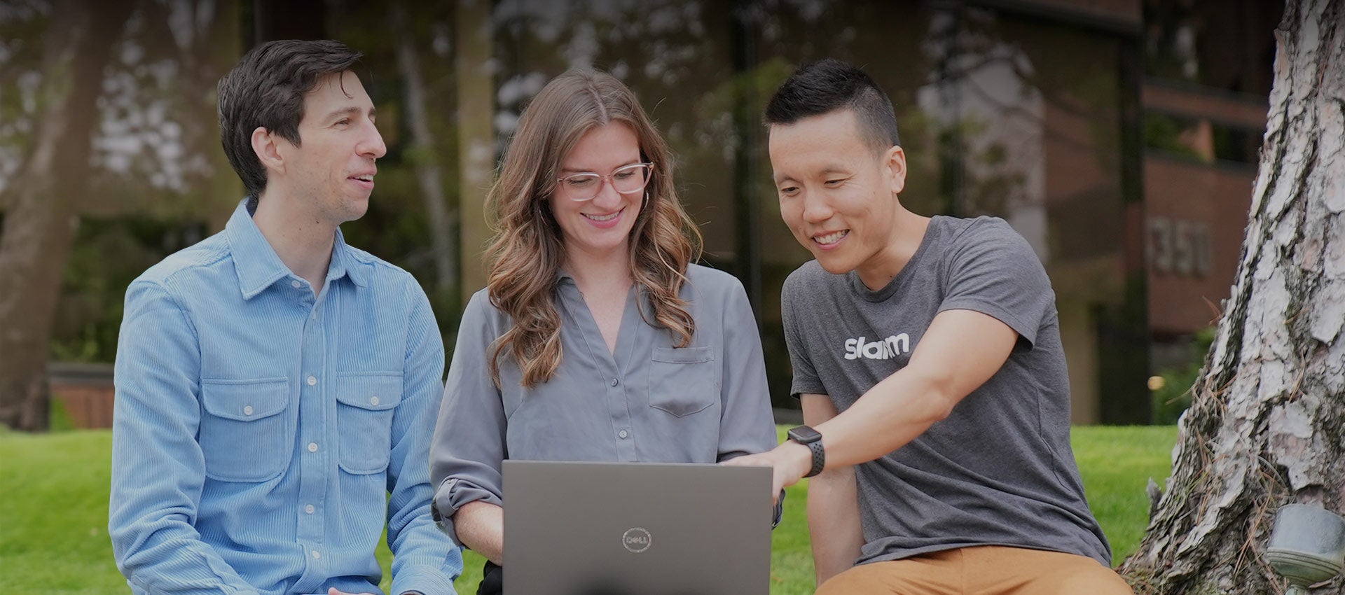 Three Slalom employees work together to build a solution for a client.