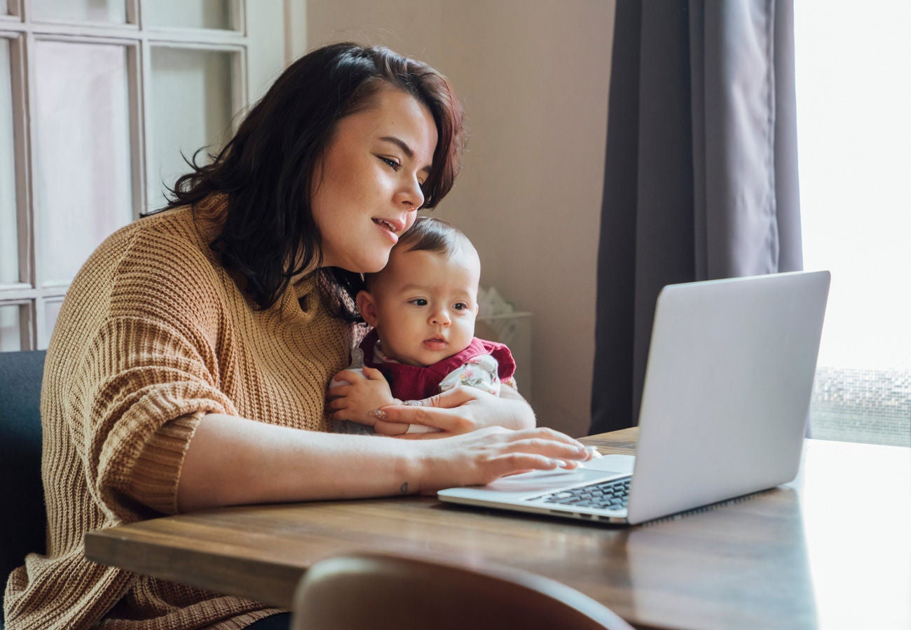 story uscis mother and baby with laptop header 1300x900 placeholder