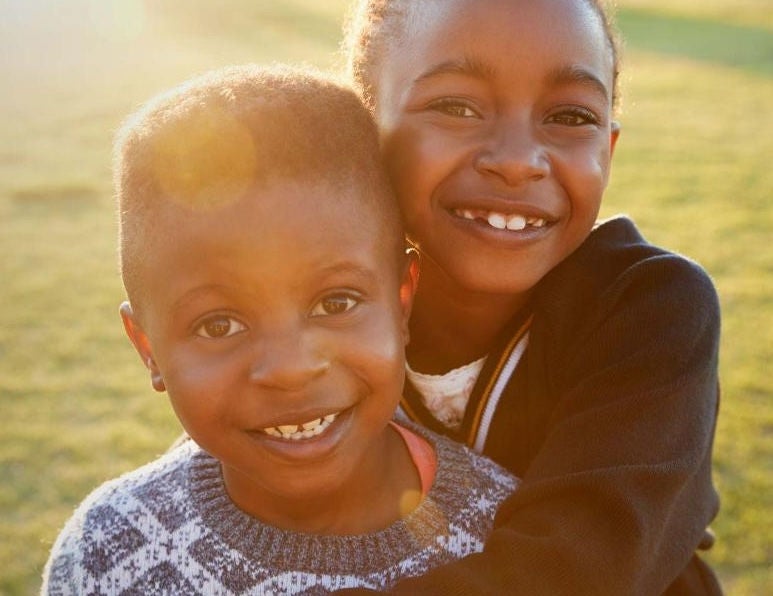 two boys smiling outside