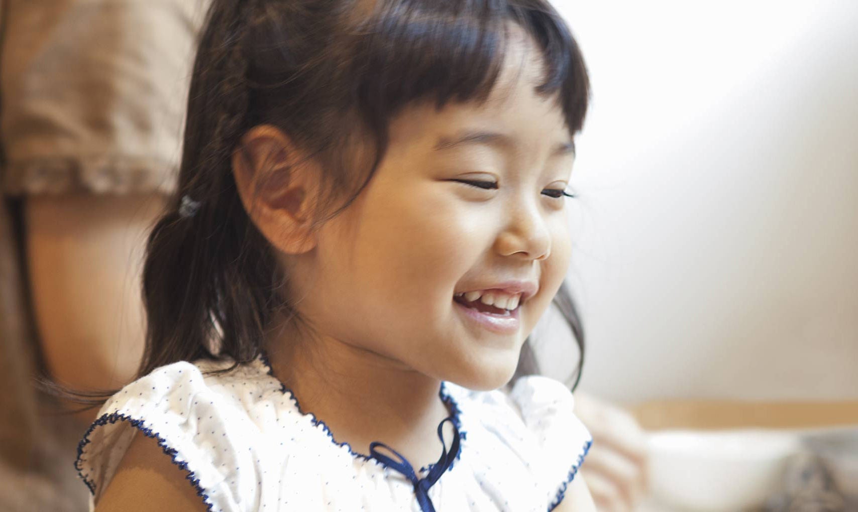 Smiling young girl at home.