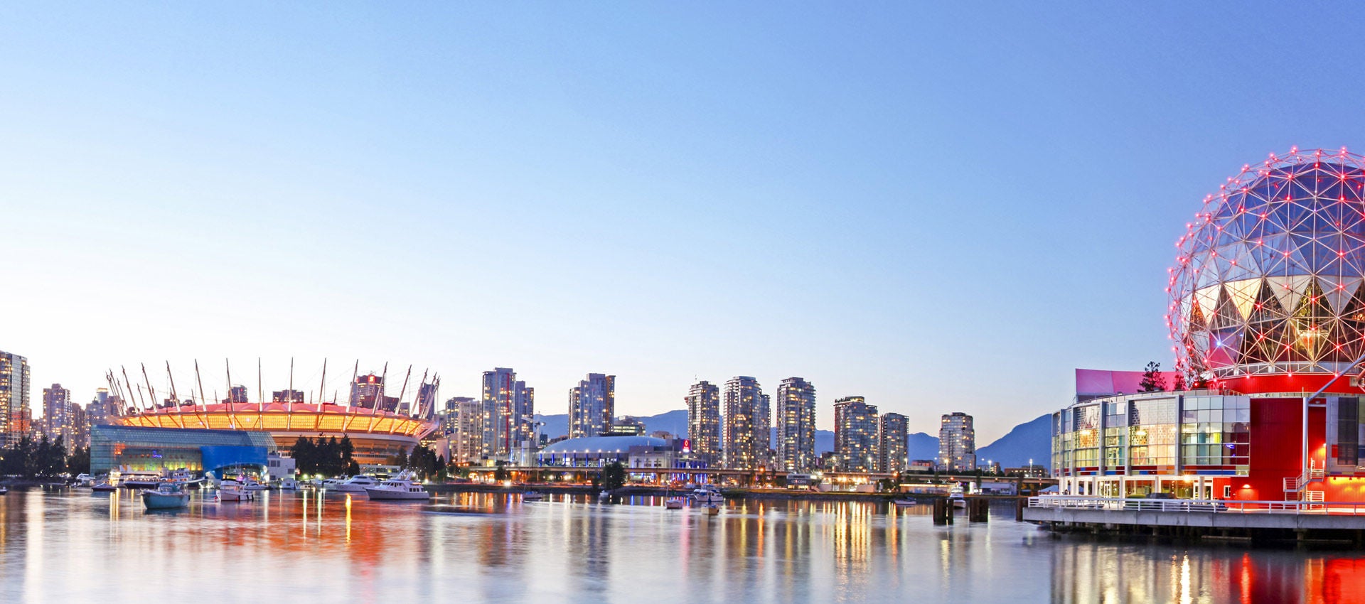 The lights of Vancouver fill the horizon as the sunsets on the city.