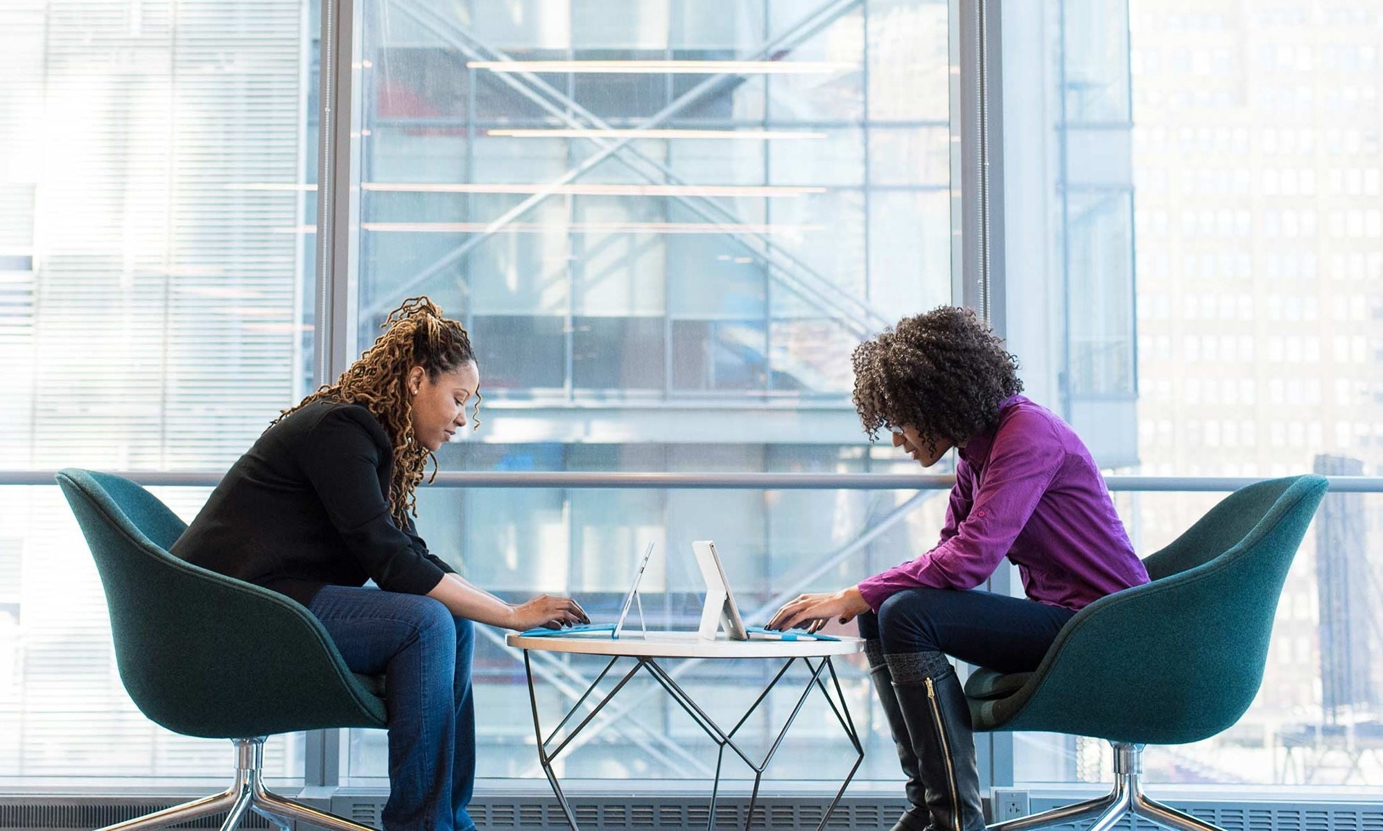 Two women working at a table in a banking instituation