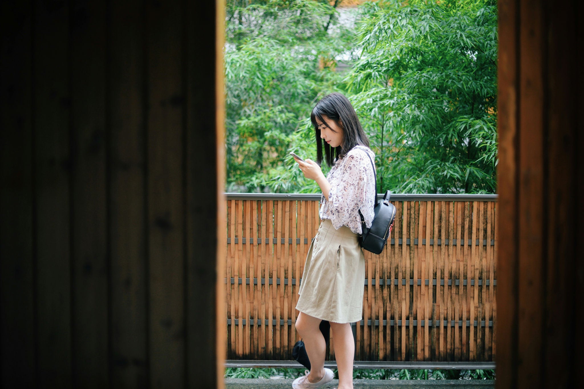woman looking at phone outside