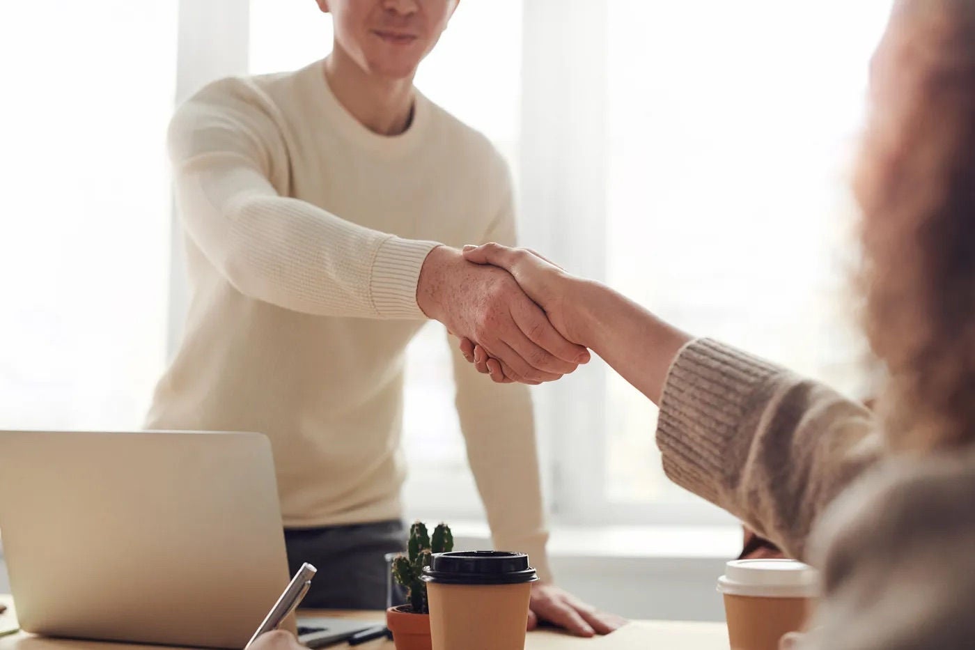 Handshake in a meeting between two people. 