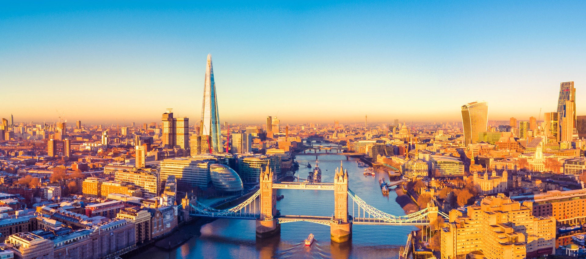 The Tower Bridge is seen as it spams the River Thames on a sunny evening in London.