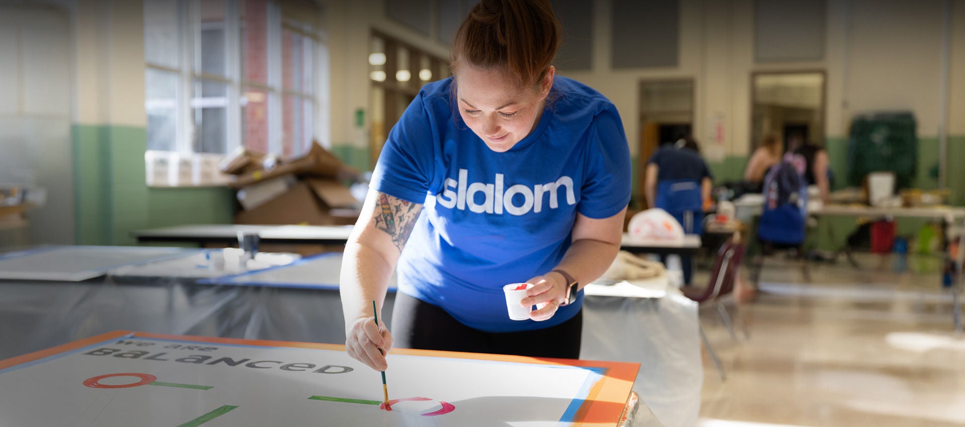 A Slalom employee paints new decorations for a local elementary school for MLK Day of Service in Atlanta.