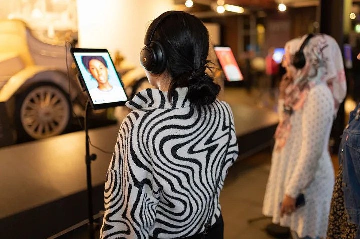 Woman watching tablet at event