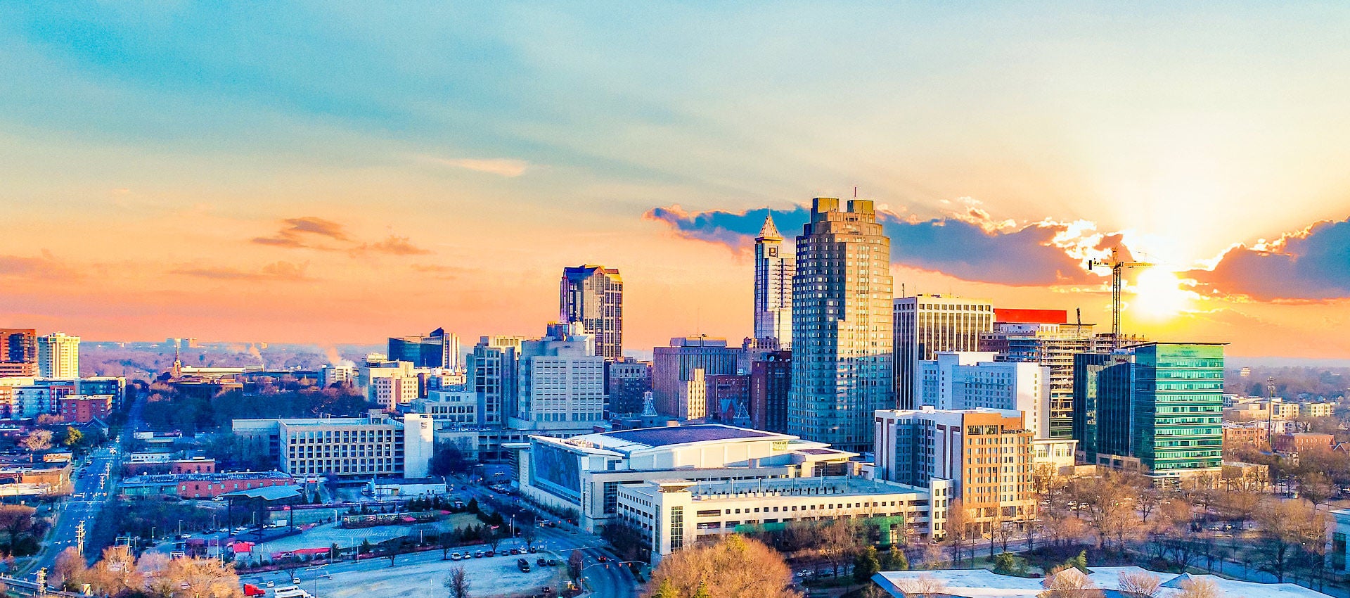 A colorful sunset fills the sky around downtown Raleigh, North Carolina.