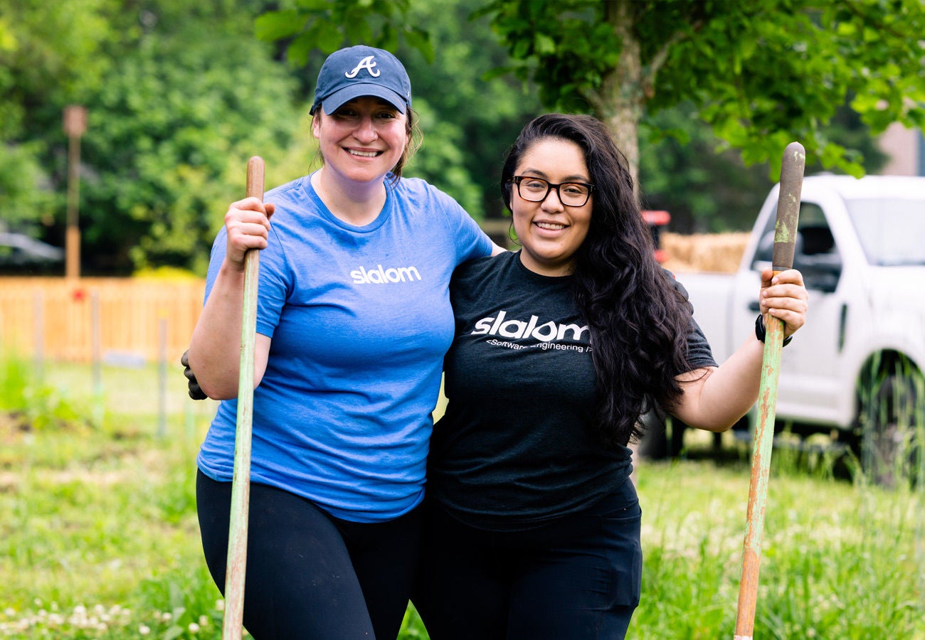 Two Slalom employees pose for a photo while volunteering.
