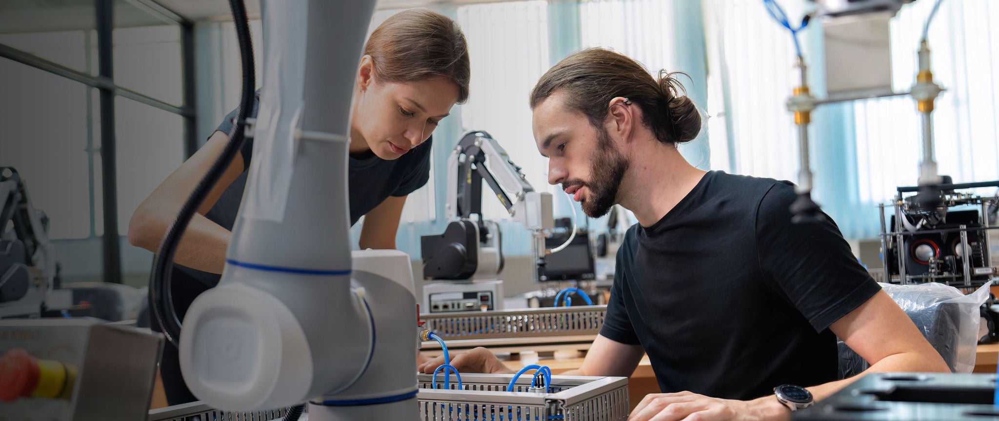 Two engineers collaborating in a robotics lab