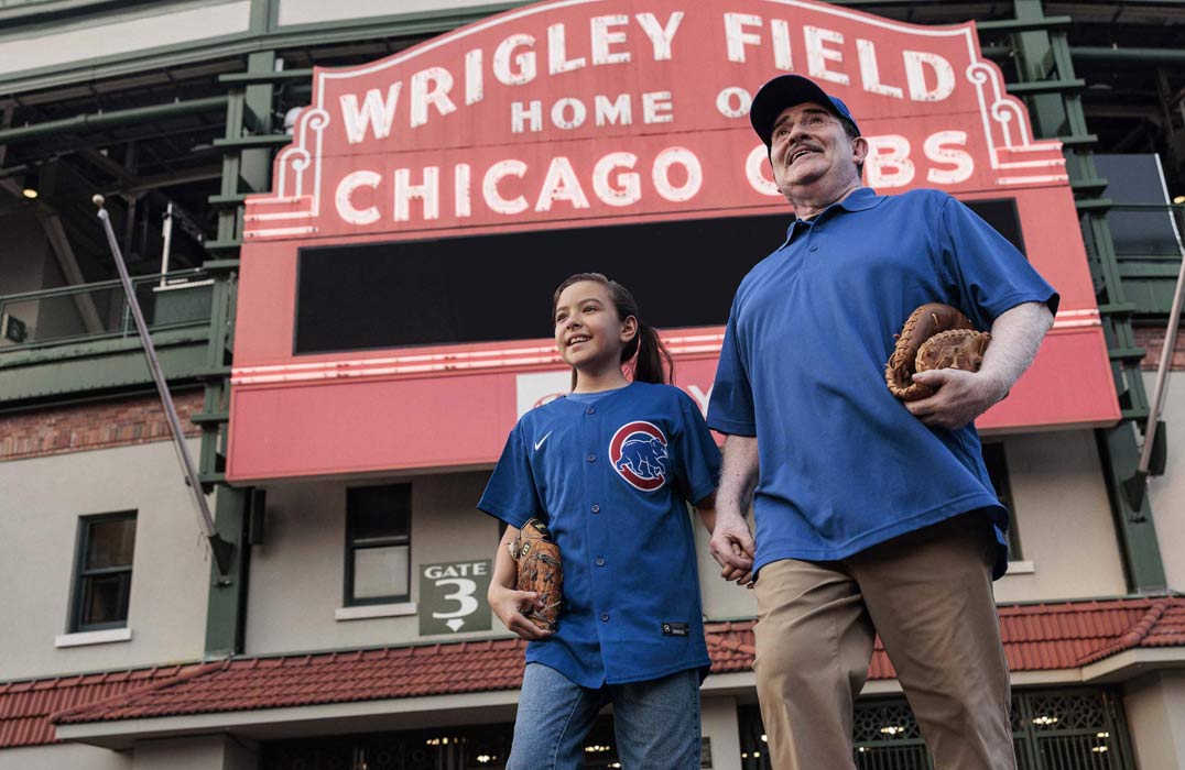 Young girl and grandfather walking to Wrigley Field. 