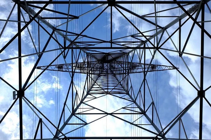Looking up at the sky under an eletrical post.