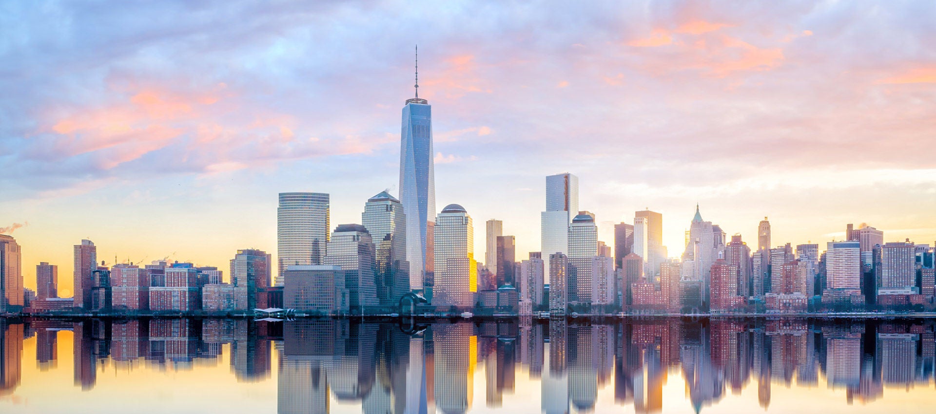 The sunrises over Manhattan skyline in New York City.