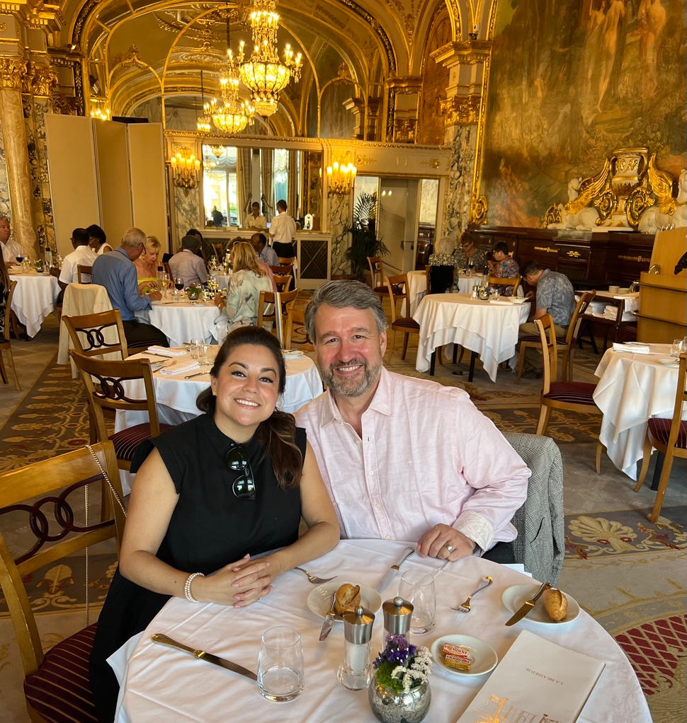 Slalom General Manager Todd Sink and woman sitting at restaurant table.