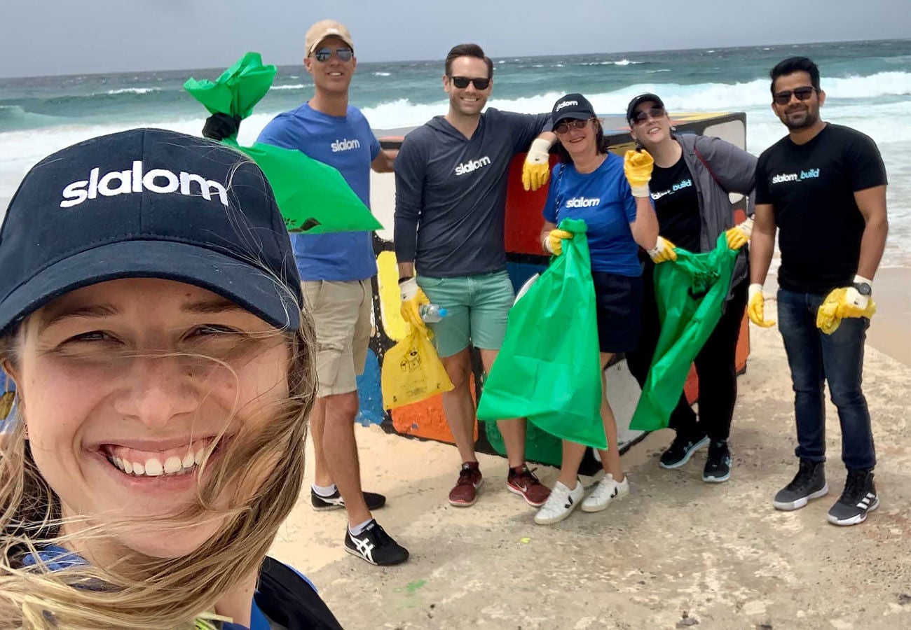 A team of Slalom employees volunteer to clean up the beach.