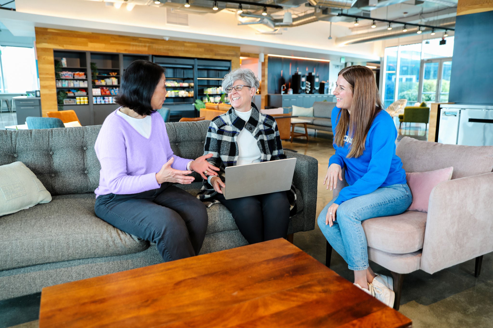 Slalom employees engage in a conversation inside the office.